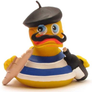 Canard en plastique habillé en marin avec une baguette, un vin et une moustache.